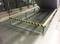 Metal railings with yellow and black warning stripes surround a small stair landing in a modern, clean environment.