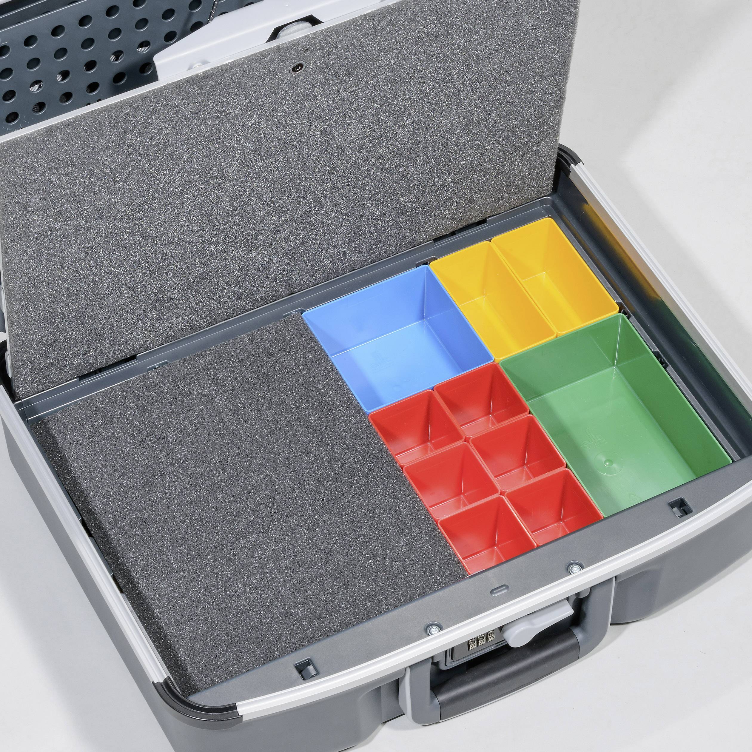 An open suitcase with compartments in different colours: blue, red, green and yellow, which serve for organised storage.