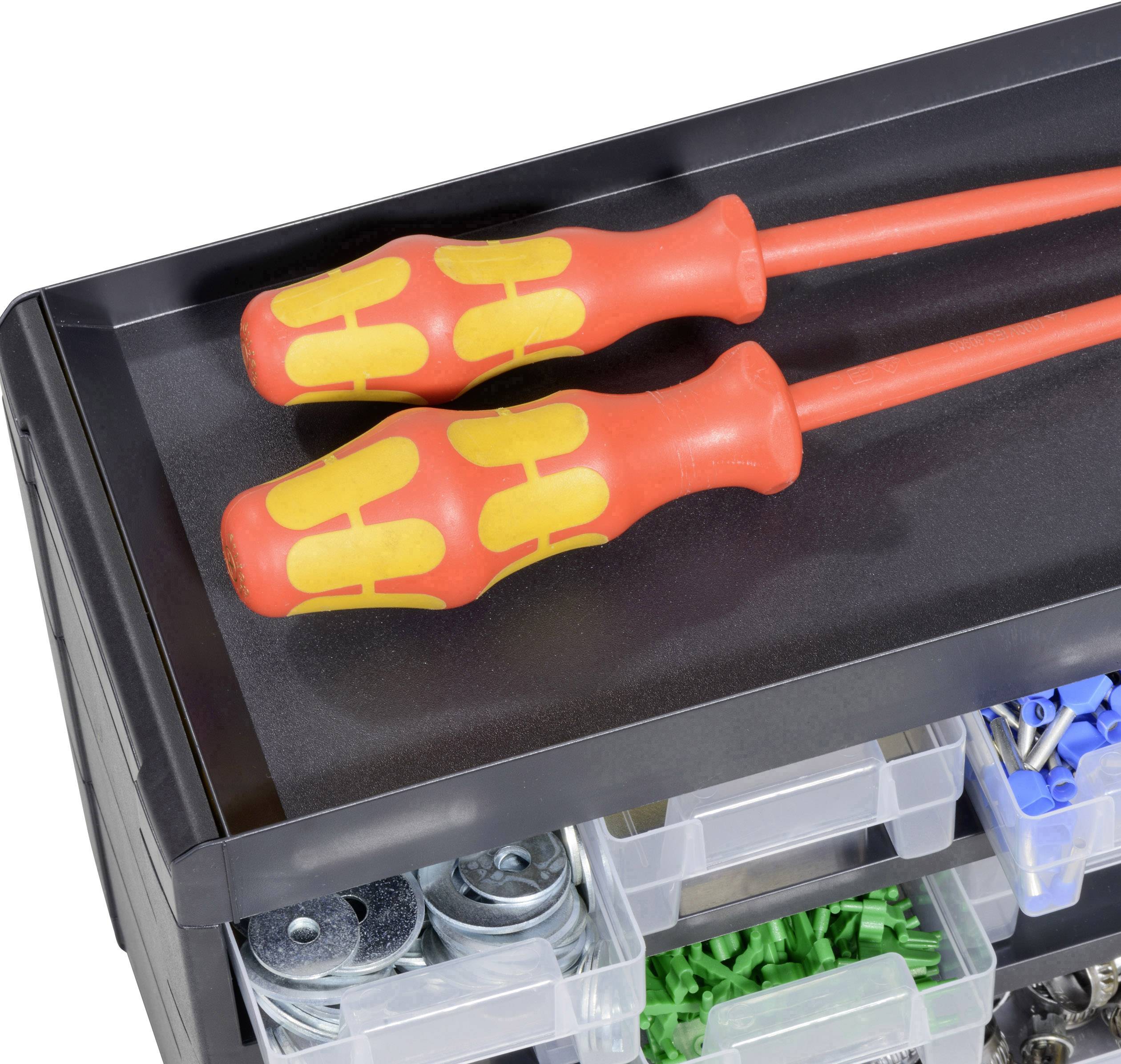 Two red screwdrivers with yellow details are lying on a black toolbox, which contains several compartments with screws and wall plugs.