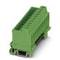 Green connector block, rectangular in shape with multiple connection points, used for electrical connections in control cabinets.