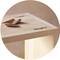 Close-up of a wooden dowel and wood shavings on a table.