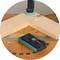 A piece of wood is connected to a wooden table with an angle bracket. A screwdriver lies beside it.