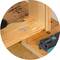 Wooden joint with two screws and matching drill holes. An angle measurement tool lies on a wooden beam.