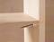 Wooden shelving unit with a poorly fitted screw causing a plank to split.