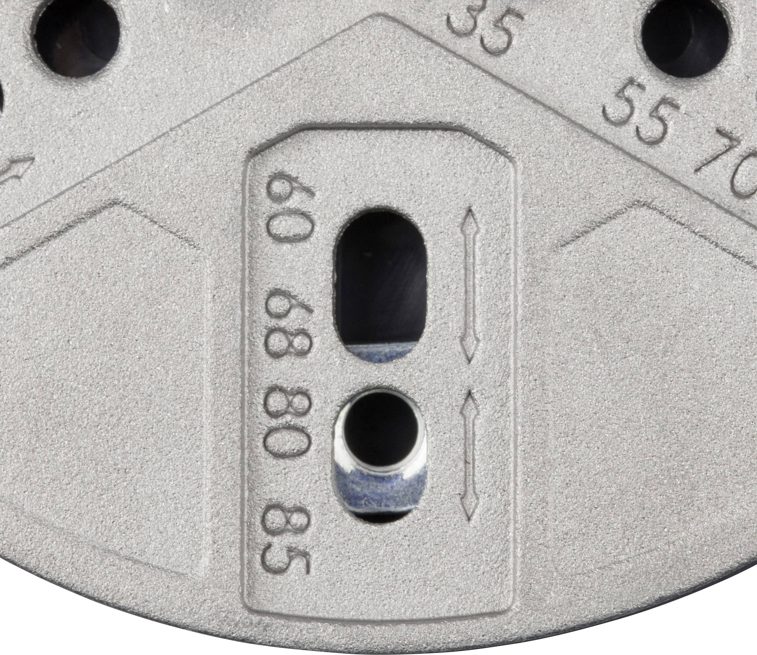 A silver metal part with markings: '35', '55', '70', '60', '80', '85'. Two vertical slots are located in the centre.