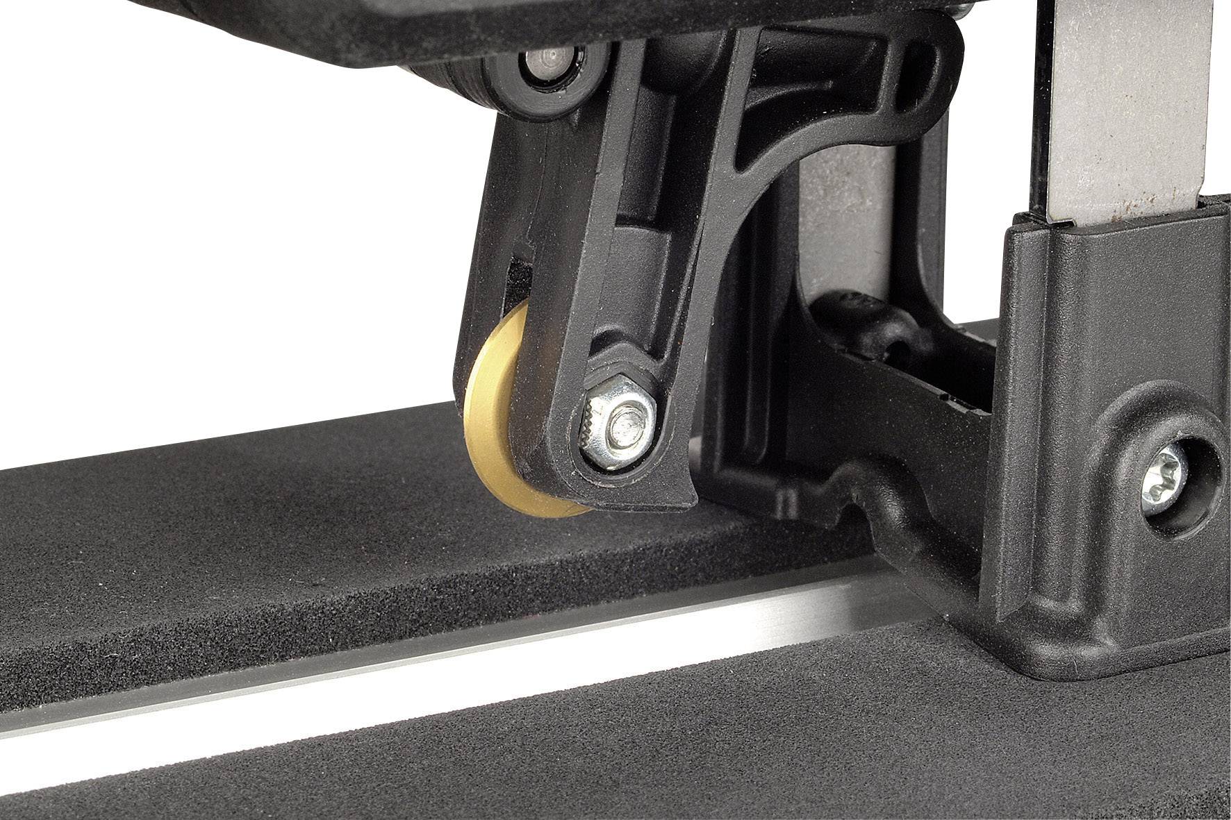 Close-up of a black plastic component of an electronic device with a small yellow roller, mounted on a metallic surface.