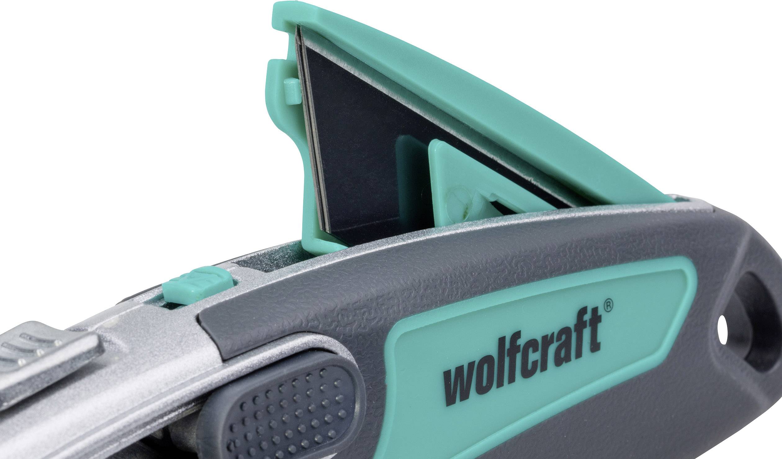 A Stanley knife with a green and grey casing and a retractable blade; 'wolfcraft' brand printed on it.