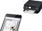 A smartphone wirelessly sends a document to a printer, which is currently printing it.