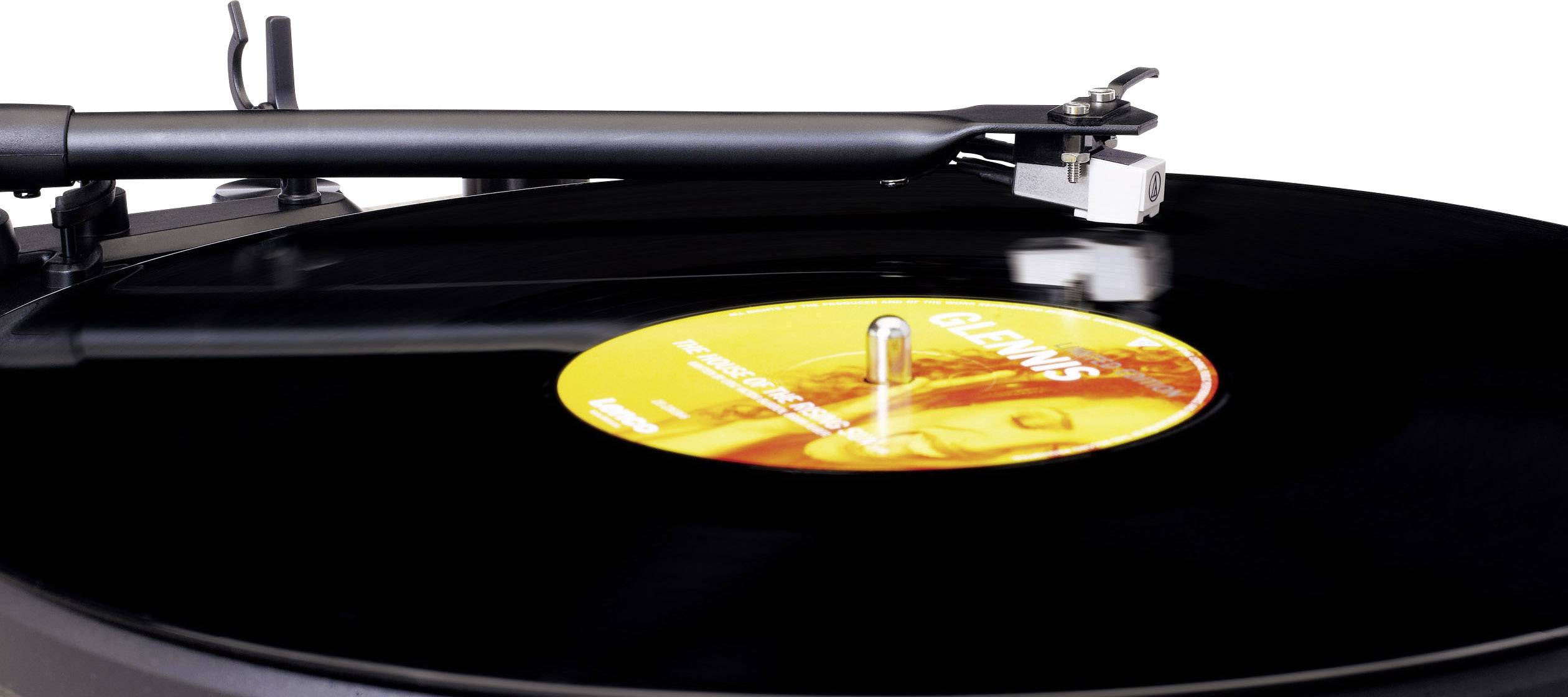 A record player with a black vinyl record. The tonearm is lowered onto the record and ready to play.