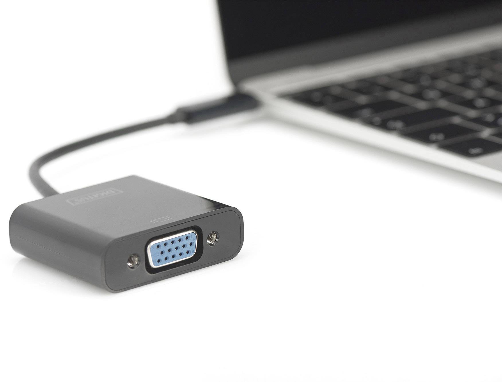 A VGA adapter is connected to a laptop. The adapter is black and the port is blue. It is used to connect to external displays.