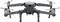 Grey drone with four rotors, flying in the air, viewed frontally from the front.