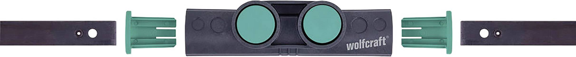 A black tool with green handles, likely used for edge finishing or joining materials.