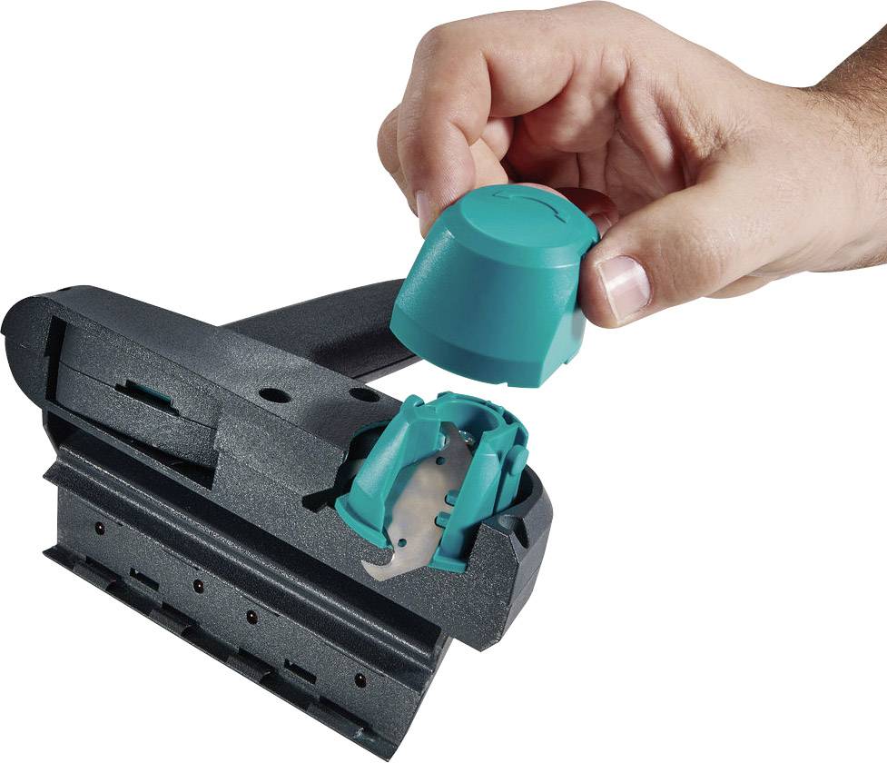 A hand holds a green container that is inserted into a black scraper. The scraper has a wide, flat blade.