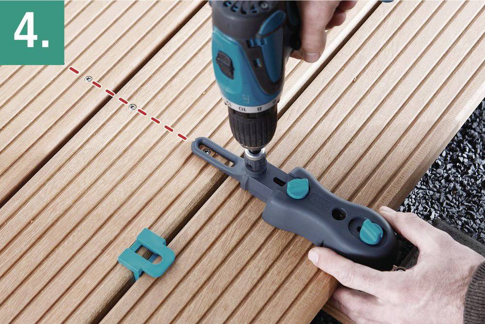 A person is securing a mounting tool to a wooden board using a screwdriver. Step 4 of an assembly process.