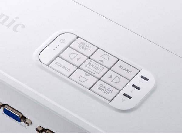 'Close-up of a remote control with buttons for menu, source, colour, and navigation. VGA port visible in the bottom left.'