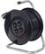 Black cable reel with metal frame, four plug sockets and a power cable. It is used to extend electrical connections.