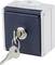 A square switchboard box with a lock in the centre. Two keys are hanging from the lock. The box is dark and light grey.