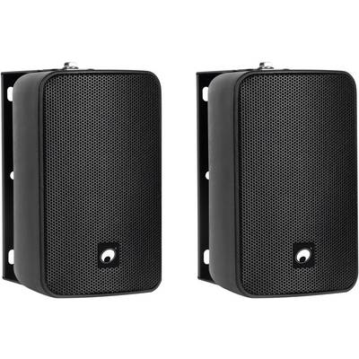 'Two black wall-mounted speakers with metal grille fronts. They are positioned side by side at a slight angle.'