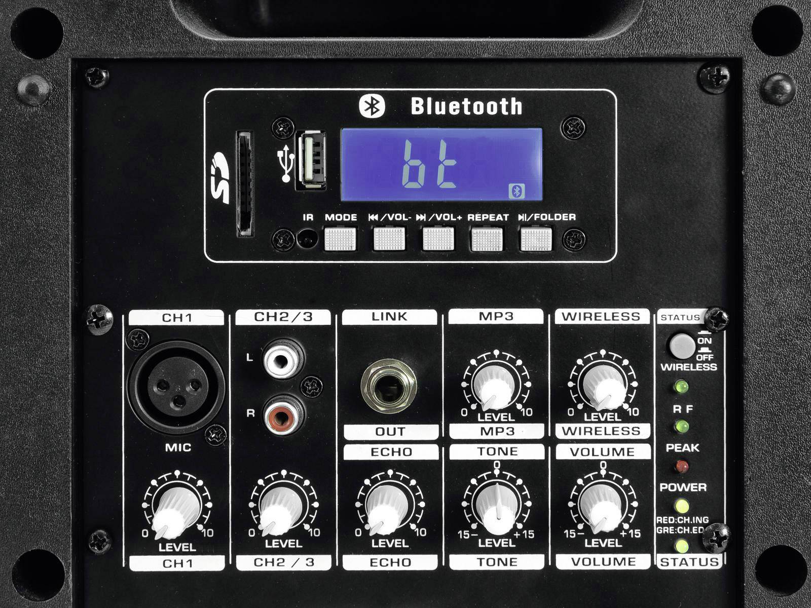 'Close-up of a speaker control panel with Bluetooth display, volume and tone adjustment buttons, and input and output connections.'