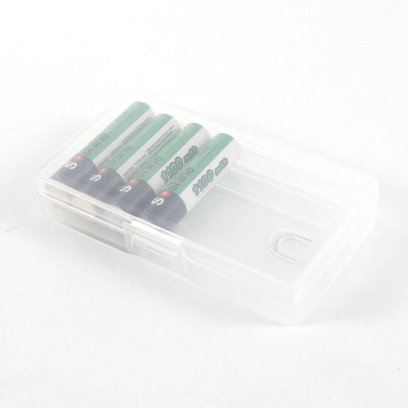 A transparent plastic box containing four green AA batteries.