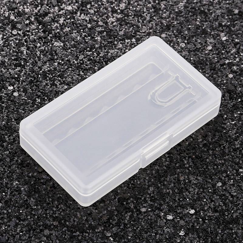 Transparent plastic box on a glittering black background, suitable for storing small items.