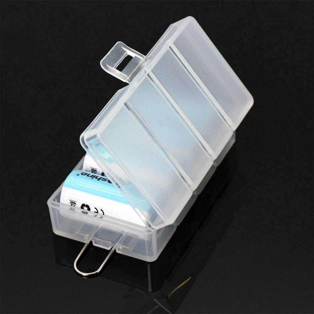 A transparent, open plastic box containing a white eraser, set against a black background.