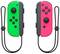 Two detachable controllers, the left in green and the right in red, with straps. Each controller has multiple buttons for gaming control.