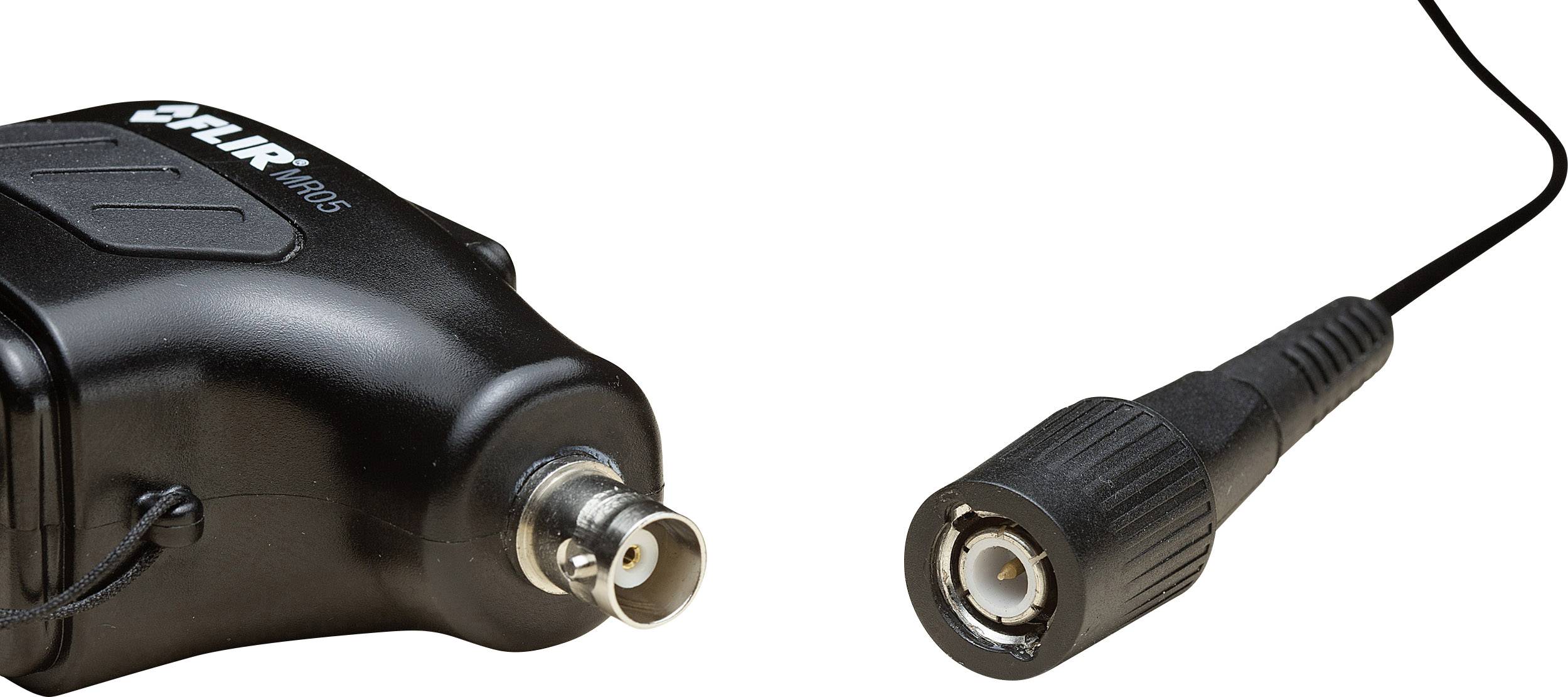'A black cable with a coaxial plug is connected to an electronic device visible on the left side of the image.'