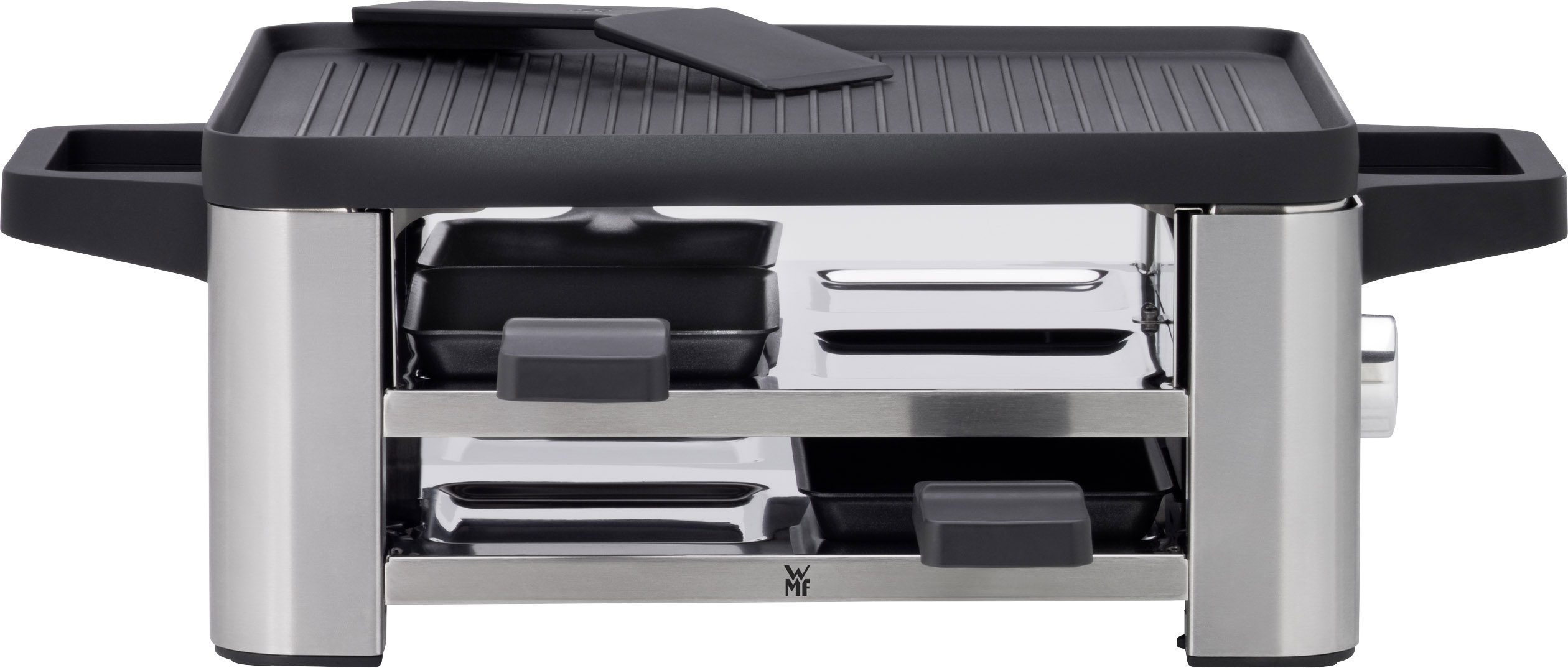 Raclette grill with metal casing, two black handles, a ridged grilling surface and underlying drawers for small pans.