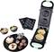 A green waffle maker with different baking plates for doughnuts, filled pastries and mini cakes. Alongside finished baked goods.