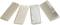 Four rectangular stones in various beige shades lie side by side on a white surface.