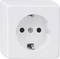 White electrical socket against a neutral background. Square-shaped with a circular opening in the centre.