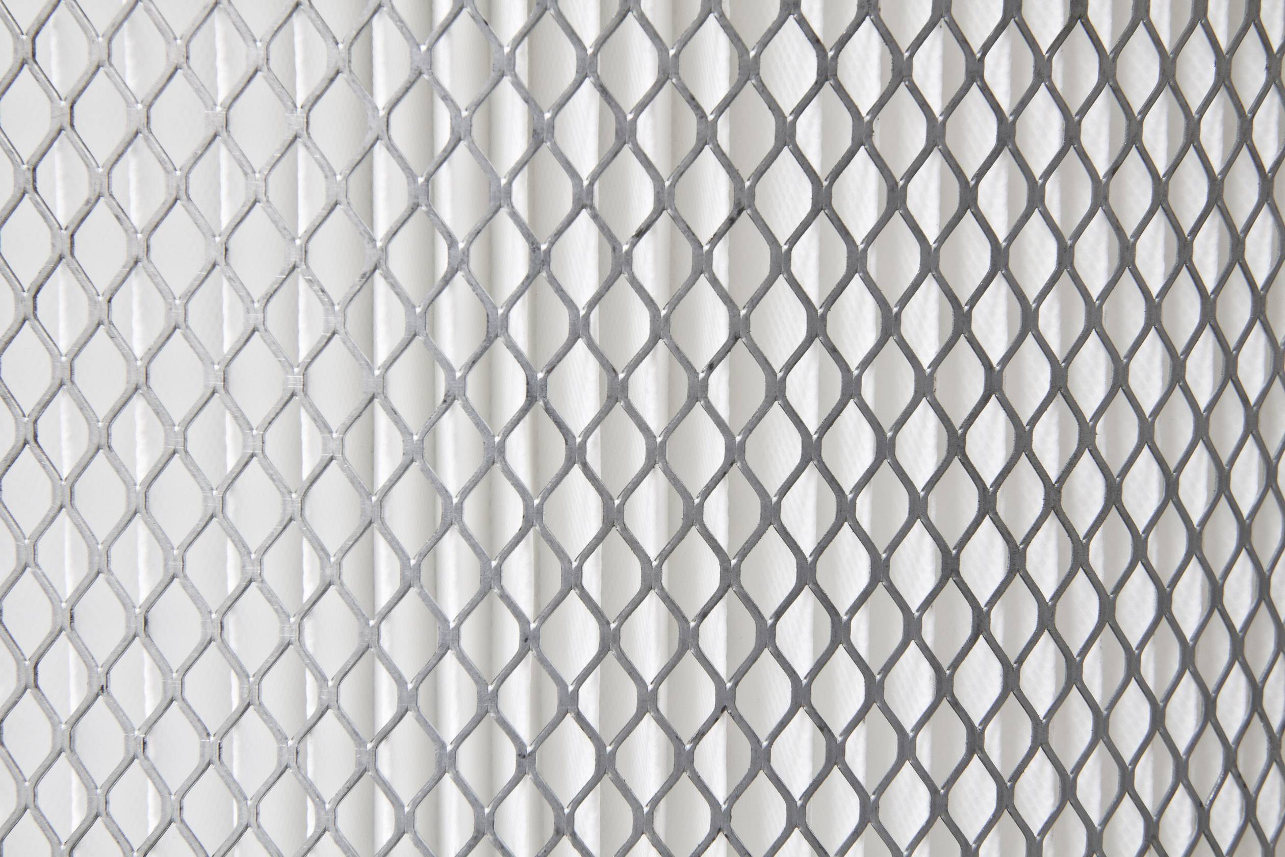 A fine-meshed wire mesh against a light background.