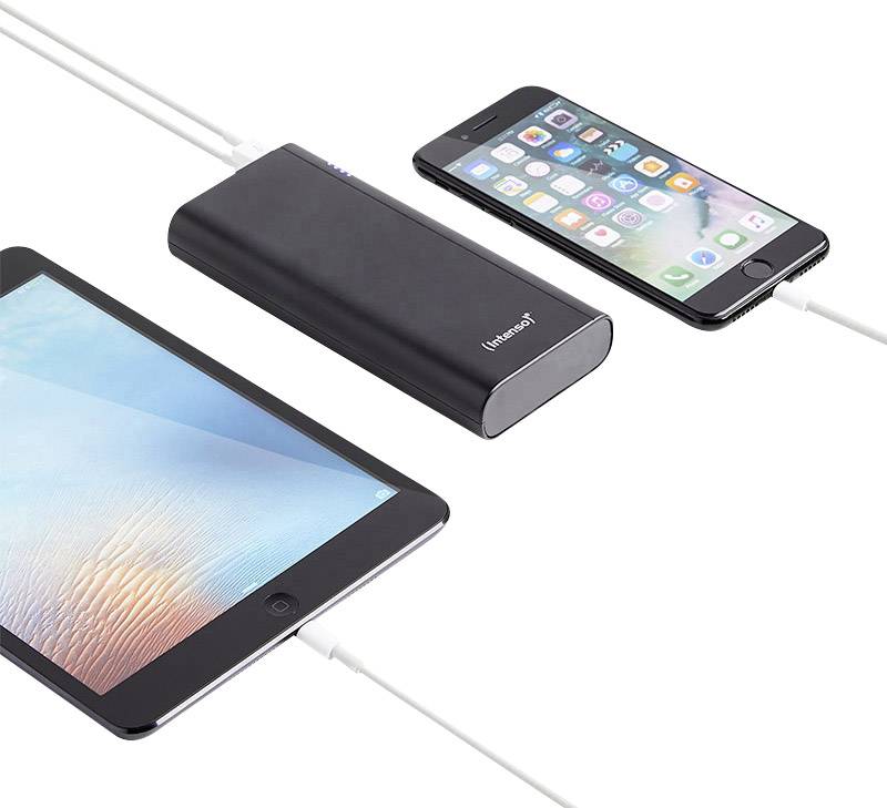 Tablet and smartphone connected to a power bank with a cable; devices being charged simultaneously.