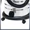 Metallic vacuum cleaner with a black hose and wheels on the underside. Suitable for industrial cleaning tasks.