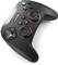 A black, wireless game controller with two joysticks and multiple buttons for video game control, lies diagonally.