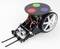 A small, autonomous robot with two large wheels and coloured markings on the top surface, showing cables and sensors.