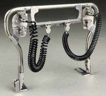 Device with a metal frame and two spiral cables, possibly a technical connecting element or mounting bracket.