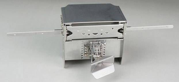 A foldable, silver camping stove made of metal with side handles and a folding mechanism for easy storage.