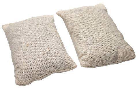 Two rectangular cushions made of coarse, beige fabric are lying side by side on a white surface.