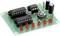 Green circuit board with several red LEDs, two integrated circuits, two capacitors and resistors, likely for an electronics project.