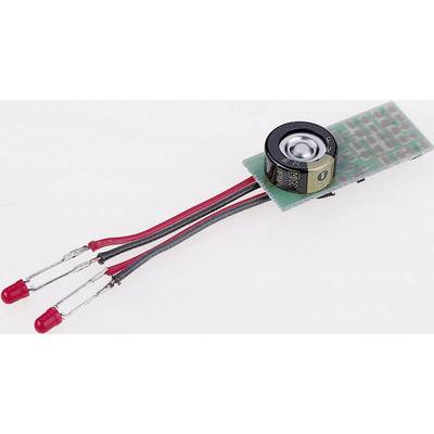 Electronic circuit with two red LEDs, a small round component, and a circuit board.