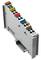 Grey-white electronic module with multiple coloured connectors and labels on the top surface.