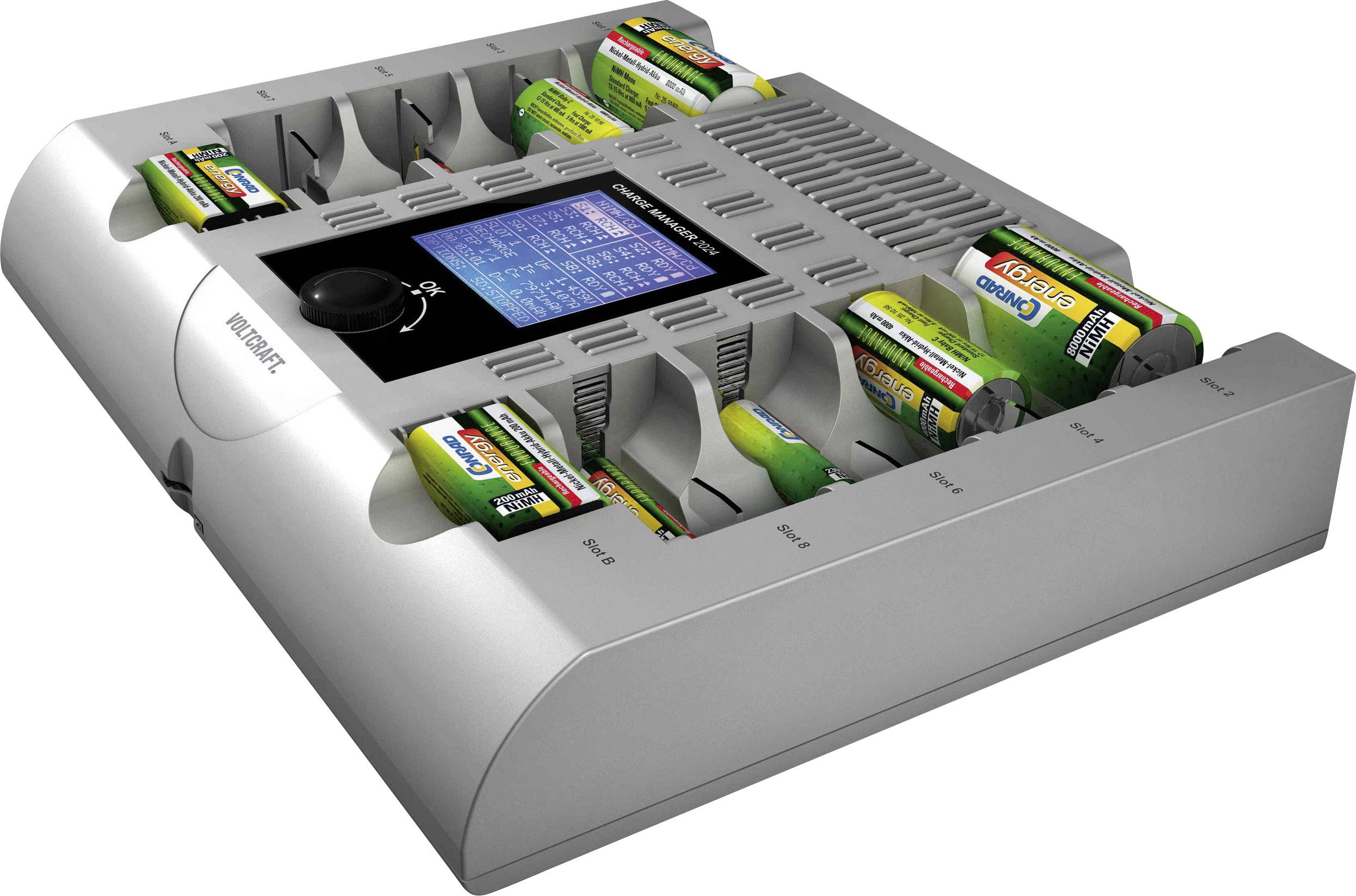 A battery charger with eight compartments charges different types of batteries. A display shows the charging status of individual batteries.