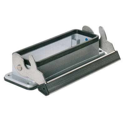 Rectangular metal holder with folding levers on the sides, mounted on a white base. Suitable for cable or device connections.