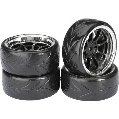 Four black, smooth car tyres with gleaming alloy wheels; two stacked, two standing upright. Tyres have a jagged tread pattern.