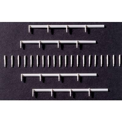 White plastic clips and wall plugs evenly arranged on a black background, many in a row, others in groups.