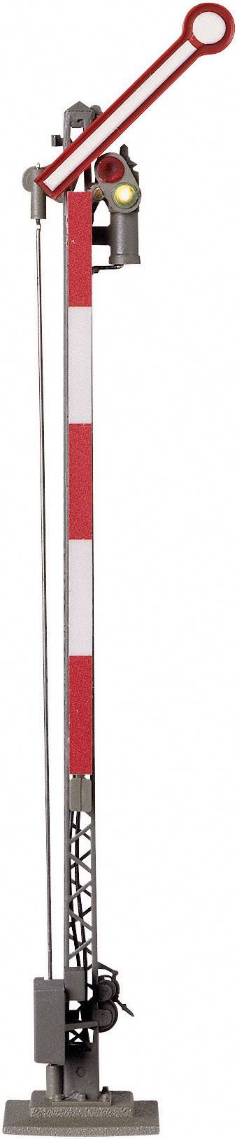 A mechanical railway signal with a red and white arm, indicating a stop signal.