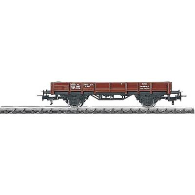 Red goods wagon on railway tracks, side view. Wagon has black wheels and white markings with technical details.