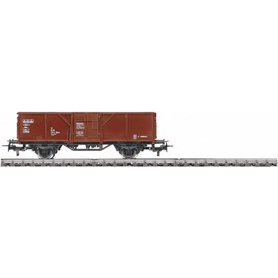 A red goods wagon is standing on a section of track. The wagon has a rectangular shape and is marked with technical identifiers.
